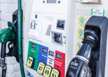 Close up of a gas pump with green, blue, white and red labels for diesel, unleaded, unleaded plus, and unleaded premium